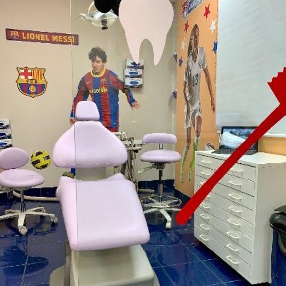 Soccer players on walls of dental office treatment room