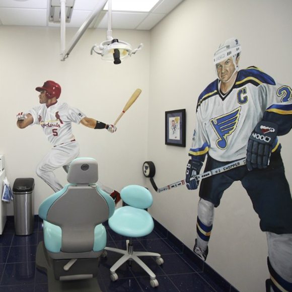 Saint Louis Cardinals and Blues athletes on walls of dental treatment room