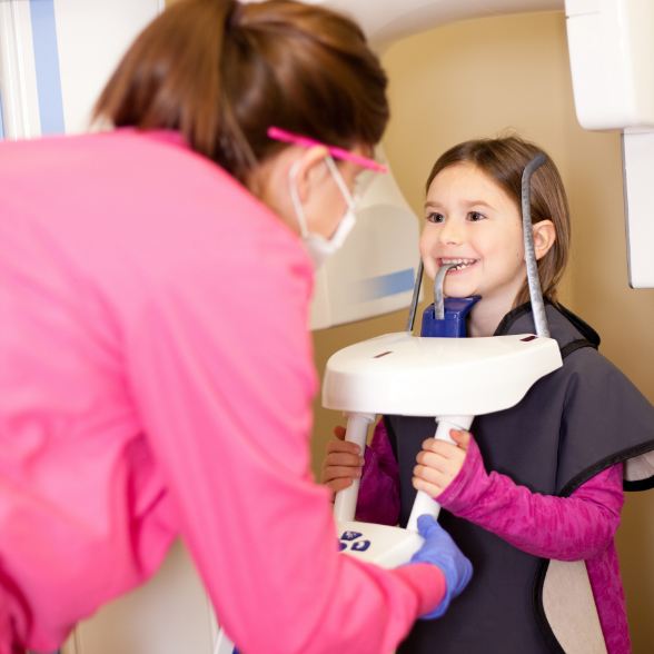 Young girl receiving 3 D C T cone beam digital x-rays scans