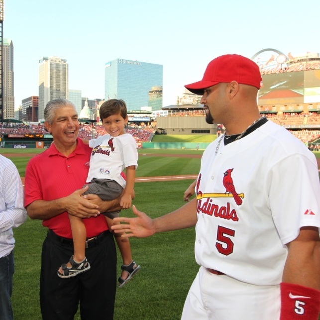 Doctor Sedighi and his family celebrating with Cardinals players after Pujols Family Foundation donation