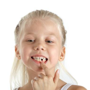 Little girl pointing to knocked out baby tooth