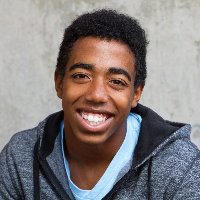 Teen boy smiling after tooth extraction