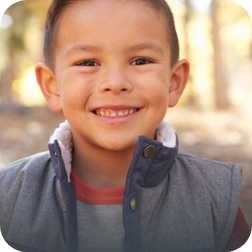 Little boy smiling outdoors