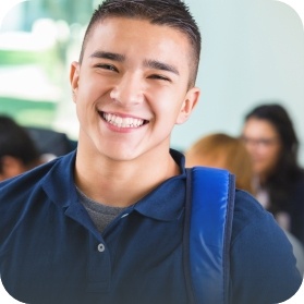 Young man with healthy smile thanks to protective dental sealants