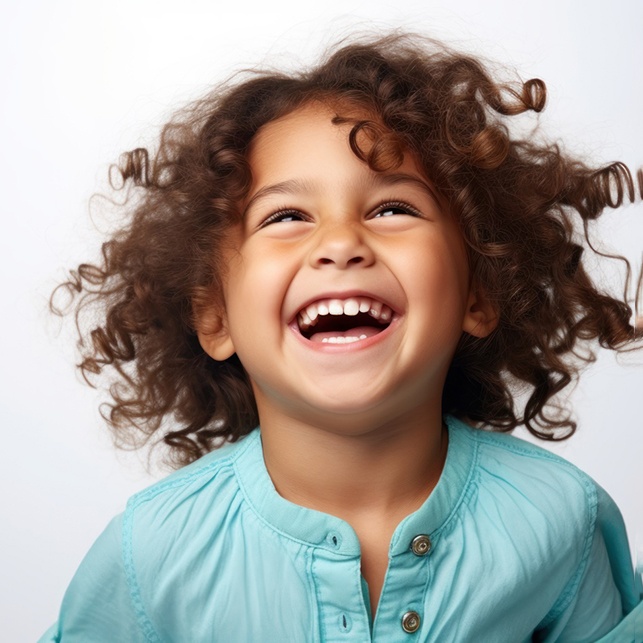 Happy, laughing child against neutral background