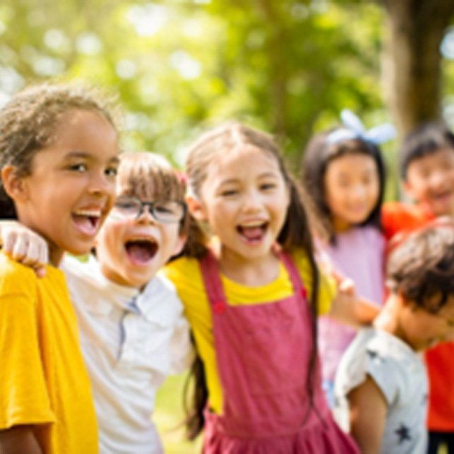 Group of kids smiling while playing outside