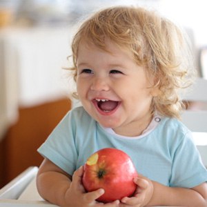 young child eating an apple
