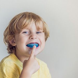 young child wearing a mouthguard
