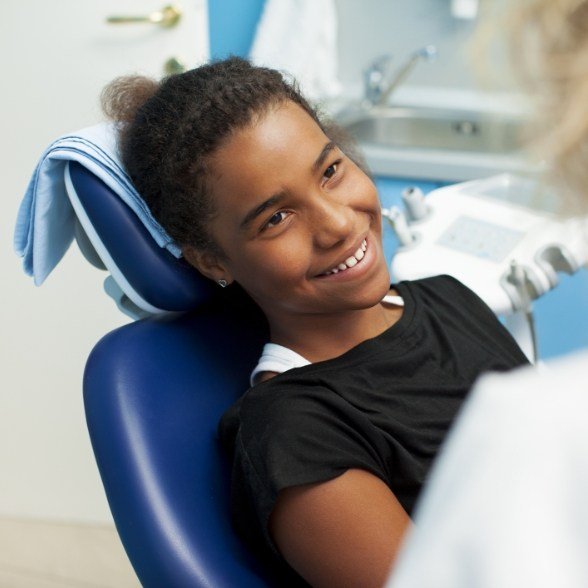 Teen girl smiling after oral cancer screening