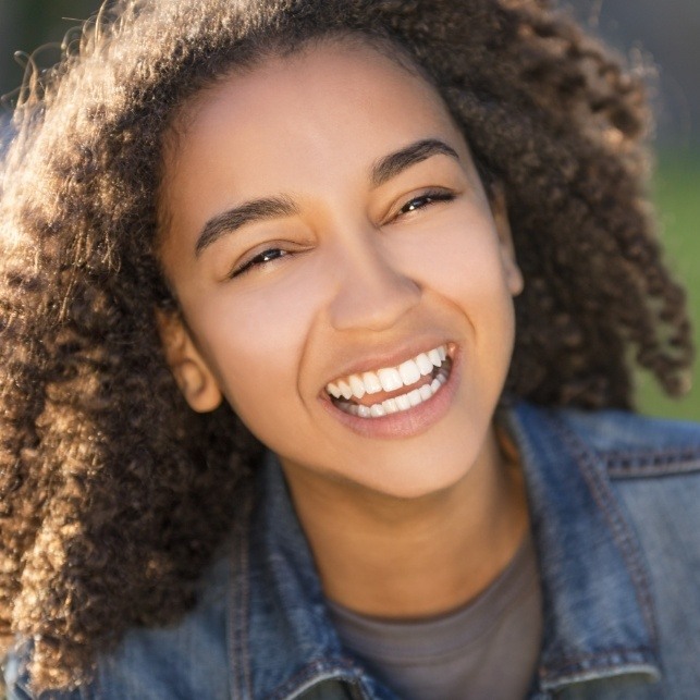 Young girl with healthy smile after restorative dentistry