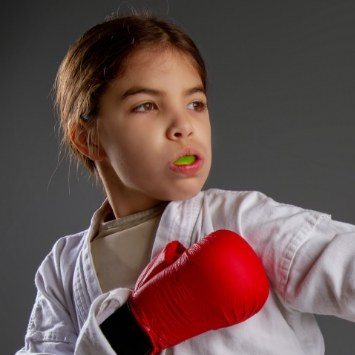 Preteen girl wearing athletic mouthguard