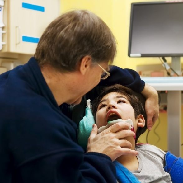 Dentist performing special needs dentistry exam