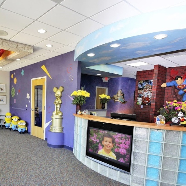 Pediatric dental office reception desk with patient images