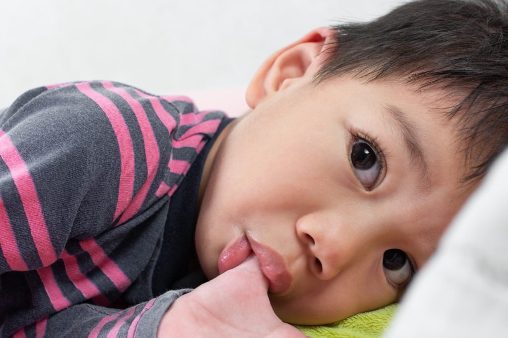 Closeup of child sucking their thumb