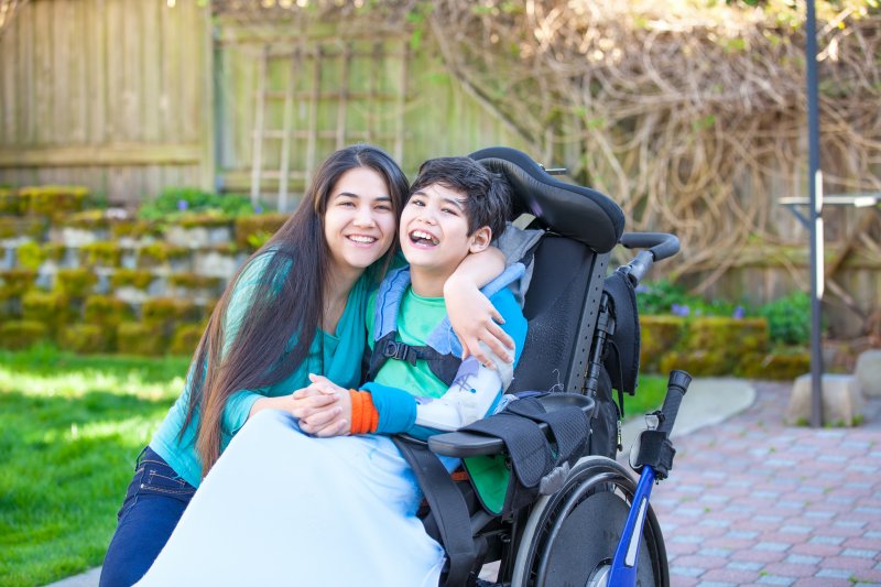 a child in a wheelchair smiling