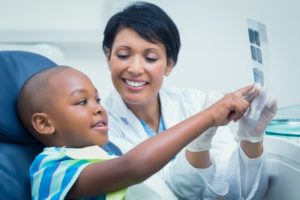 dentist showing child dental x-ray 