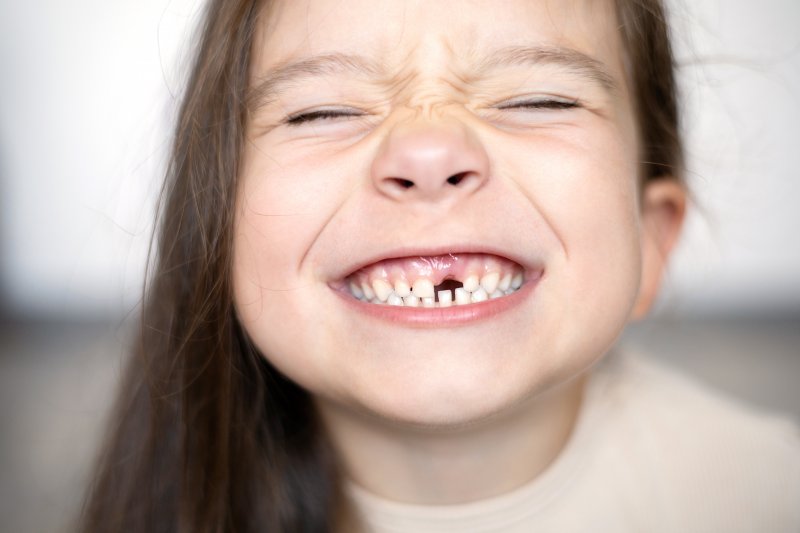 little girl smiling with missing tooth