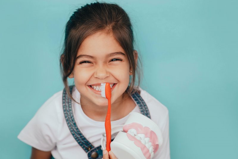 Child happily brushing their teeth