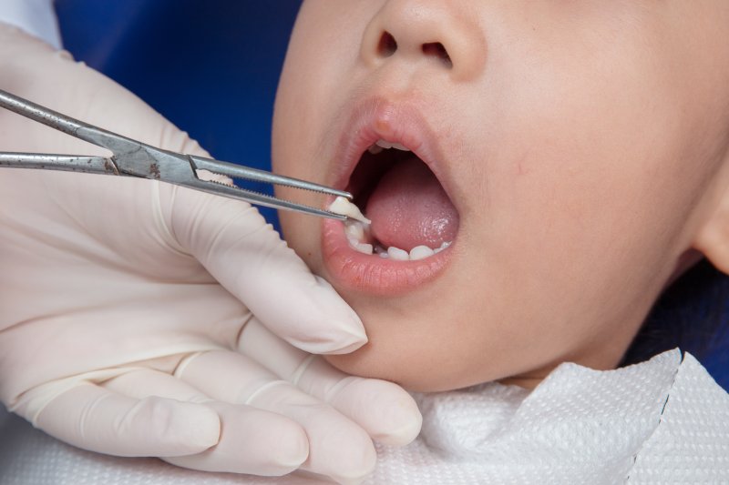 A little girl receiving a tooth extraction