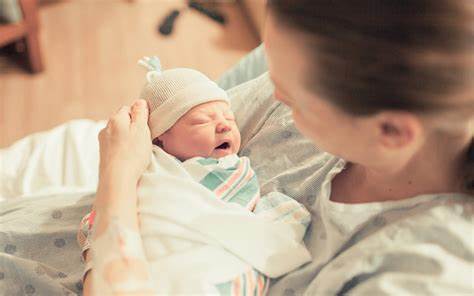 person holding newborn