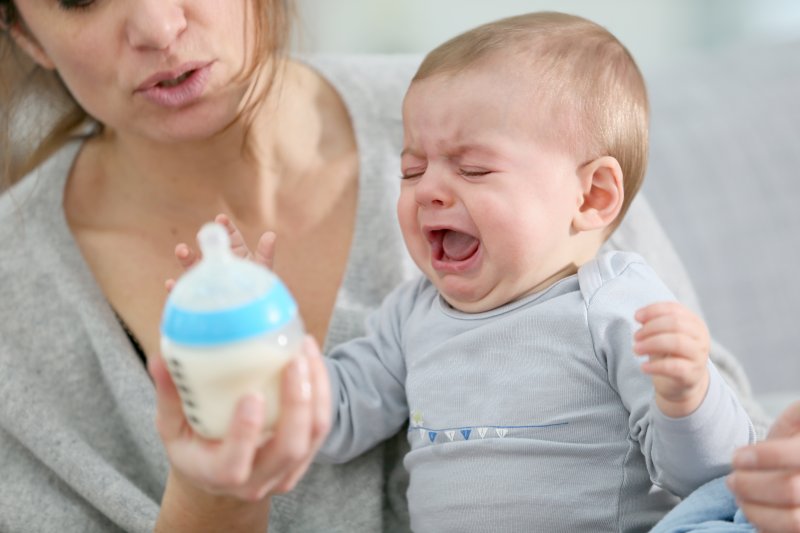 a baby with colic due to lip and tongue ties