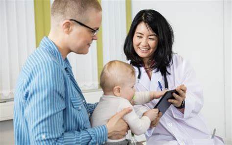 dentist speaking with patient’ and child about lip tie