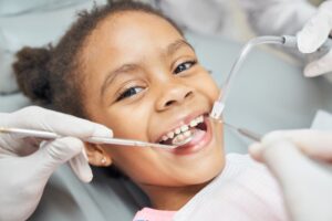 Young girl getting worked on at dentist.