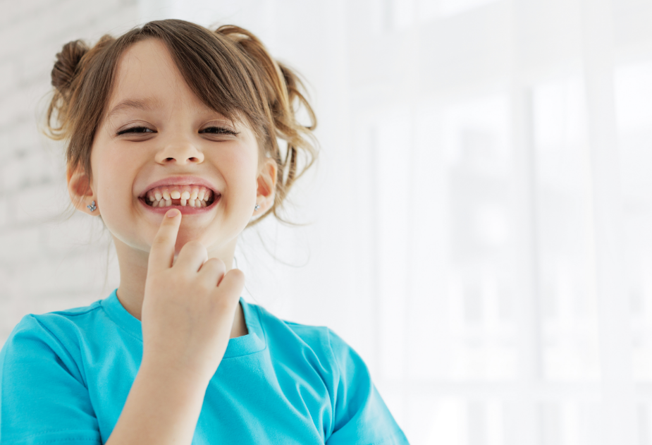 Child pointing at missing tooth