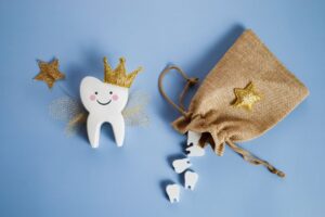 Cartoon tooth with a wand and crown