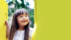 Special needs child on playground equipment.
